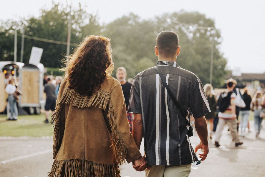 Couple holding hands walking.